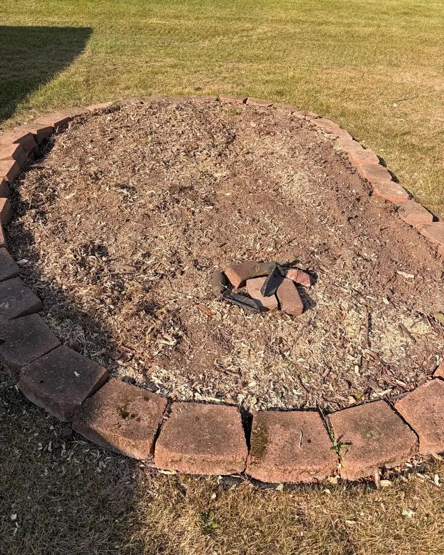 A brick edged bed ground flat where a stump used to be